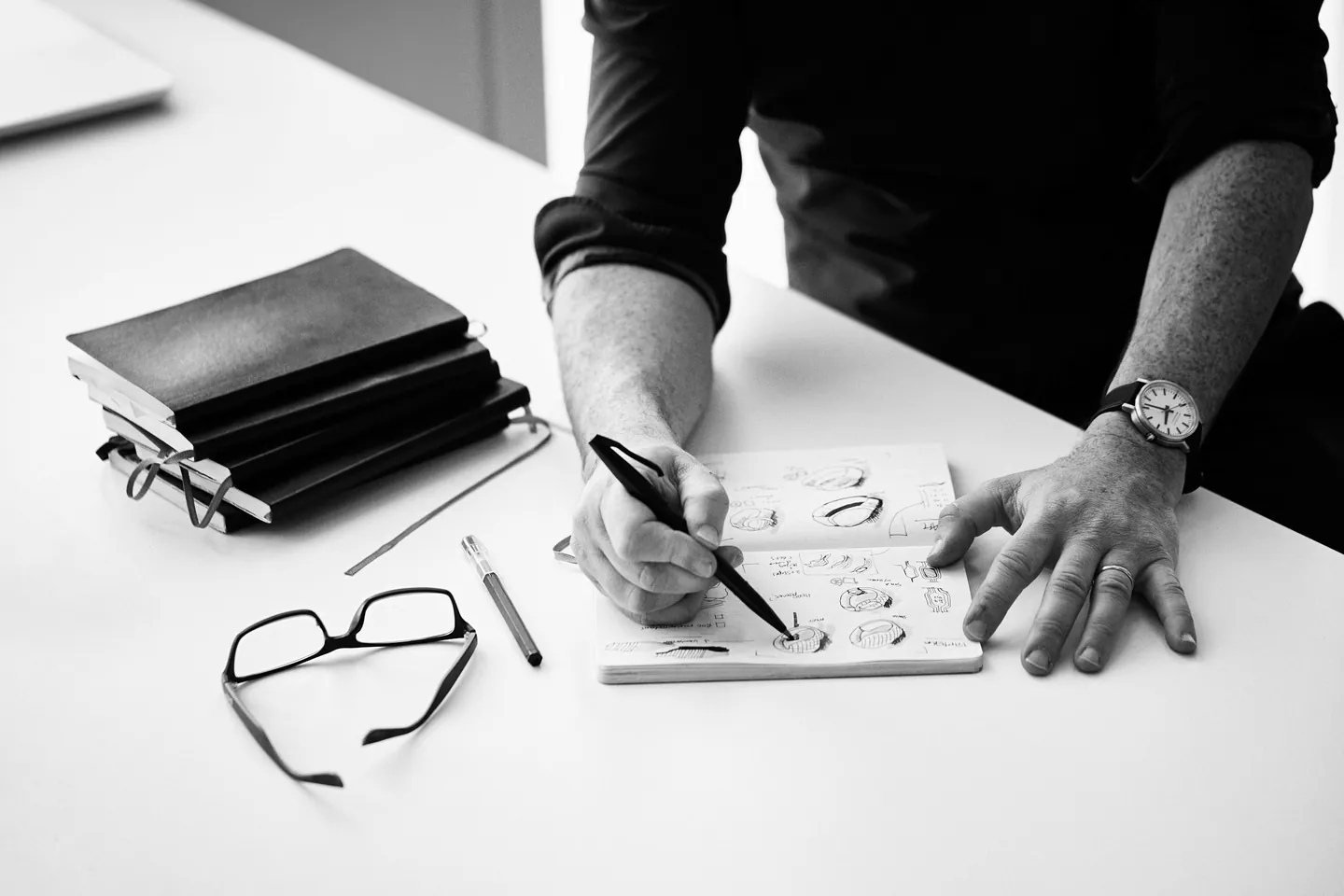 Jim Hannon-Tan sketching product ideas at a desk